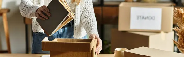 A young woman sorts books for donation, promoting sustainability, banner — Stock Photo