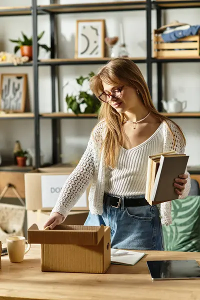 In a cozy space, a young woman sorts through clothes and books, preparing items for donation and recycling. — Stock Photo