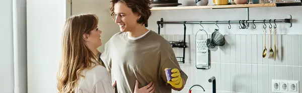 Loving couple smiles and playfully interacts in their comfy kitchen filled with warmth. — Stock Photo