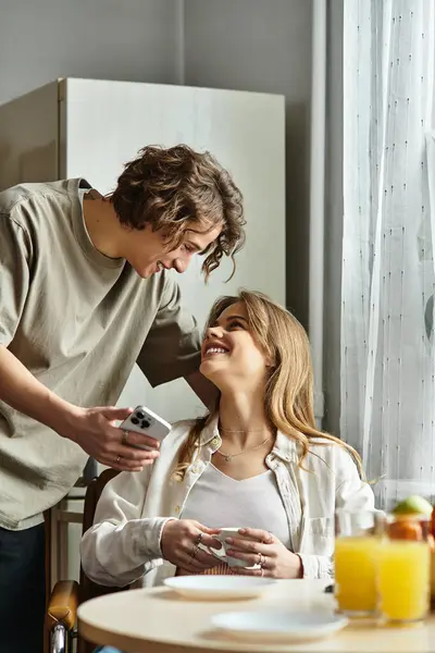 A young couple shares a heartfelt exchange at home, basking in warmth and comfort together. — Stock Photo