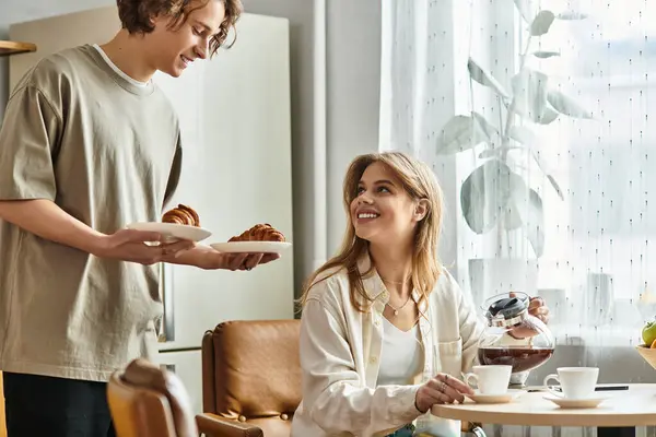 In a bright and cozy space, a loving couple enjoys a beautiful morning together, sharing breakfast. — Stock Photo