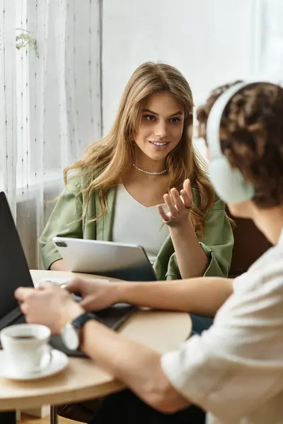 Charming young couple engaged in a delightful discussion at their comfortable home workspace. — Stock Photo
