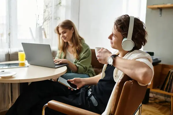 A loving couple enjoys quality time at home, each engaged in their own activities. — Stock Photo