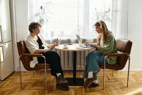 Young couple enjoys a cozy moment at home, balancing work and each others company. — Stock Photo