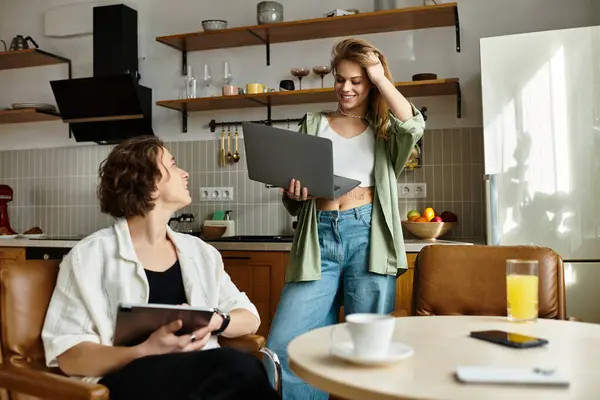 Young couple shares laughter and warmth while working in their stylish, cozy home environment. — Stock Photo
