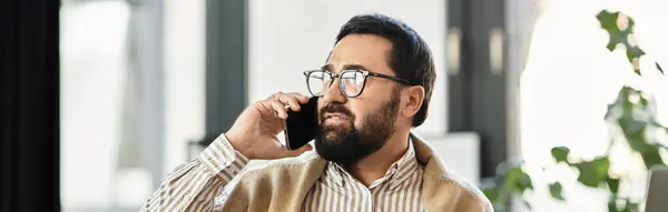 An attractive senior man speaks on his mobile device, showcasing a relaxed vibe in a well lit room. — Stock Photo