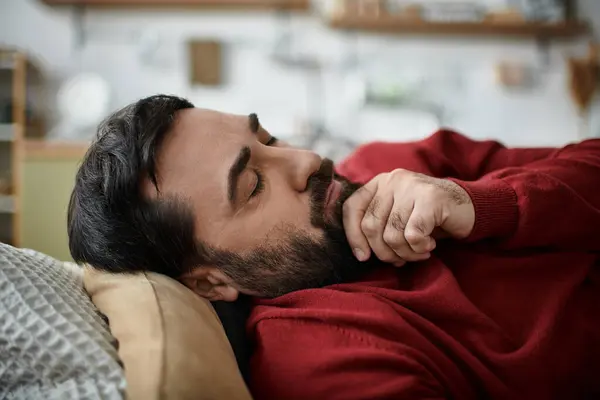 An elderly man in casual attire enjoys a moment of peace while resting indoors. — Stock Photo