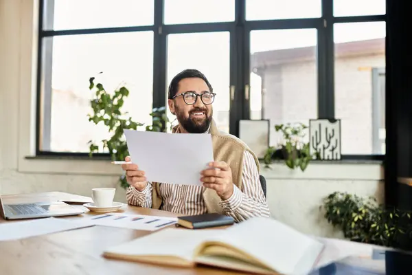Cheerful elderly man enjoys a productive moment in his bright and inviting study space. — Stock Photo