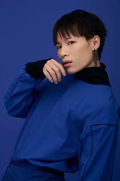 A handsome young asian man showcases a stylish blue outfit, exuding confidence and charisma. — Stock Photo