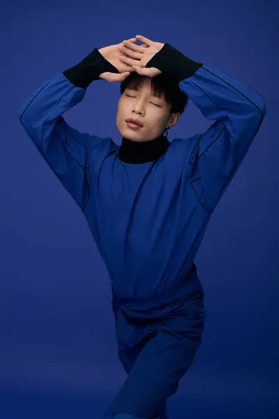 Striking young asian man showcases his fashion sense and artistic expression with a dramatic pose. — Stock Photo