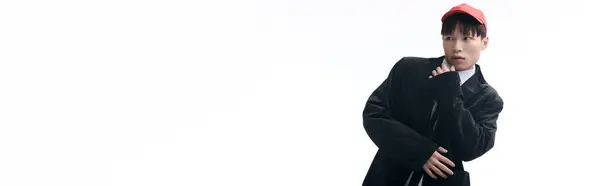 Confident young asian man dressed in trendy attire strikes a unique pose with a playful look. — Stock Photo