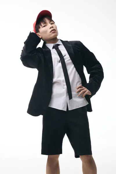 A stylish young Asian man exudes charm in a mix of formal and casual attire. — Stock Photo