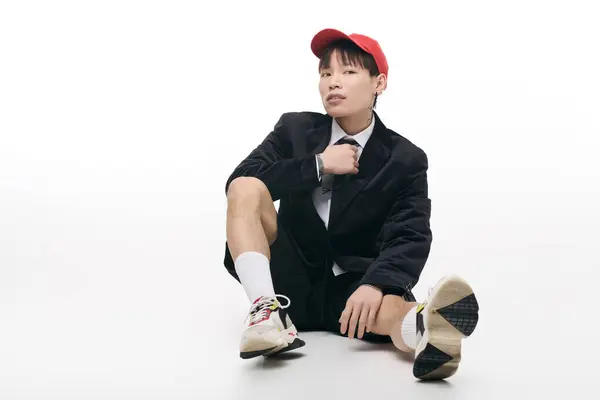 Young and attractive asian man sits confidently, blending formal and casual styles effortlessly. — Stock Photo