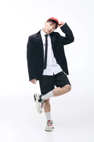 A stylish young Asian man poses confidently in a smart casual outfit in the studio. — Stock Photo
