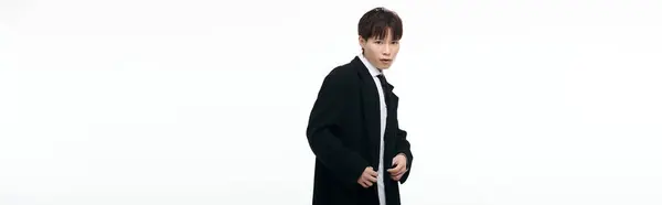 Attractive young asian man showcases stylish fashion while striking a dynamic pose in studio. — Stock Photo
