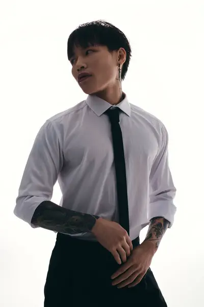 Striking young asian man showcases his charisma and style while dressed in a classic white shirt. — Stock Photo