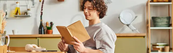 A young man reads comfortably in a stylish office during work hours. — Stock Photo
