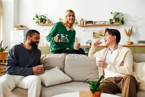 Three handsome men share a warm moment discussing literature while enjoying drinks at home. — Stock Photo