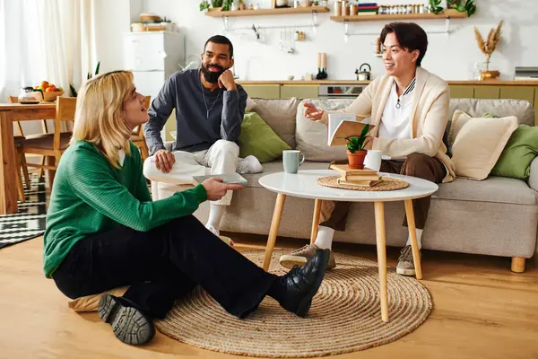 Three handsome young men share ideas while relaxing in a stylish, contemporary living room. — Stock Photo
