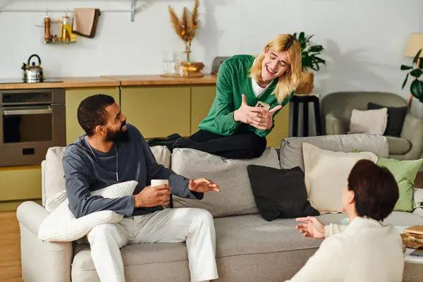 Three young men share lively conversations while enjoying a book club meeting at home. — Stock Photo