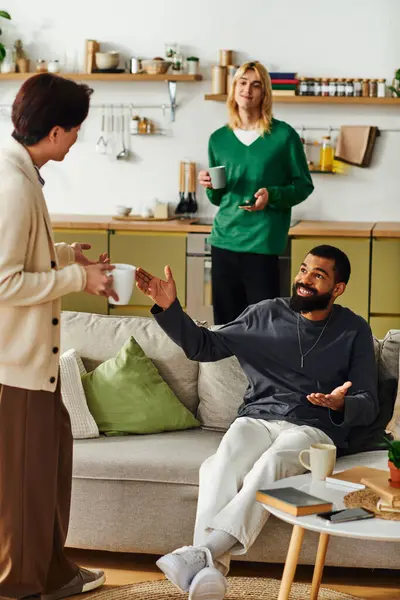 A group of young men enjoy a book club meeting in a stylish living room, sharing ideas and drinks. — Stock Photo