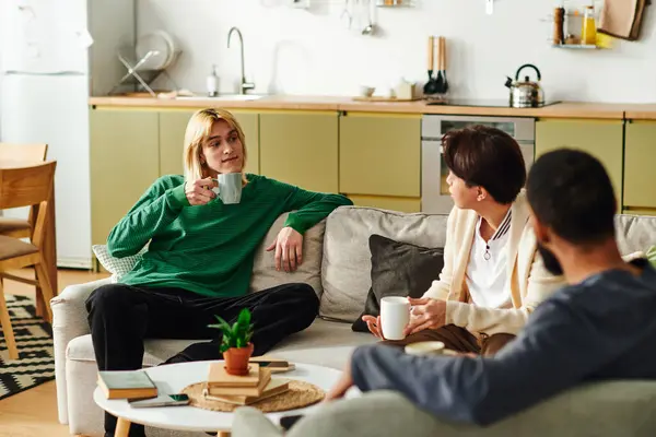 Young men share ideas and enjoy each others company during a cozy reading club gathering at home. — Stock Photo