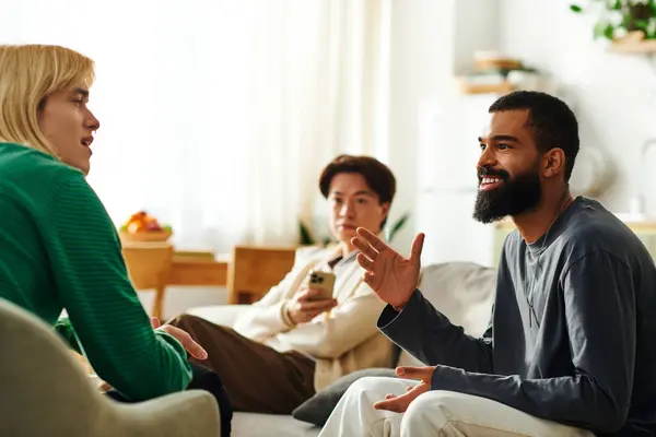 Three young men connect and share ideas during an engaging discussion in a cozy setting. — Stock Photo