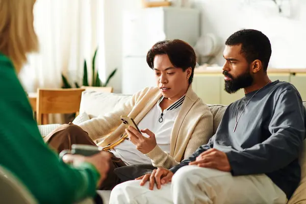 Young, diverse men engage in thoughtful discussion while enjoying a casual meeting at home. — Stock Photo