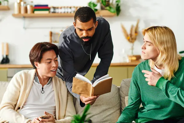 A group of handsome young men share ideas while exploring a book together at home. — Stock Photo