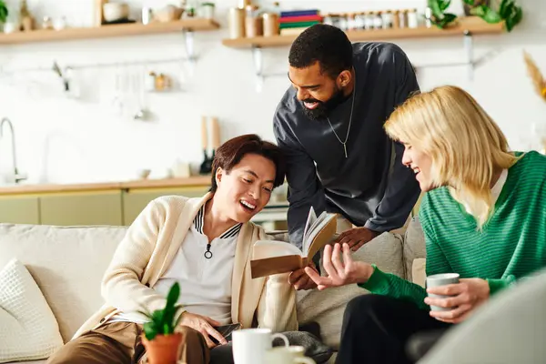 Three stylish young men share laughs and ideas while reading together in a cozy home. — Stock Photo