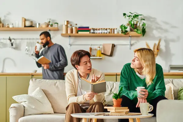 Three young men connect over books in a cozy, modern living space. — Stock Photo