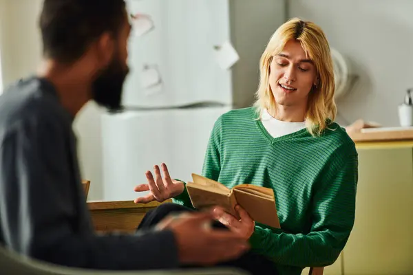 Young men connect and share insights during an engaging book club gathering at home. — Stock Photo