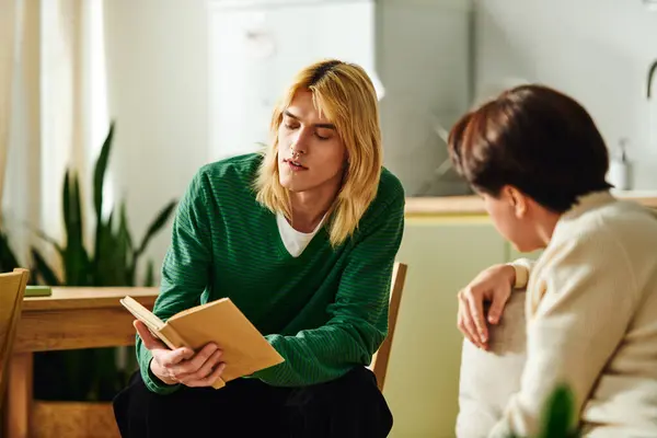 Young men share insights and stories while reading together in a stylish home environment. — Stock Photo
