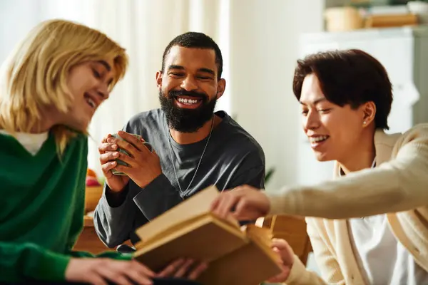 Young handsome men share ideas and laughter while exploring books in a modern home setting. — Stock Photo