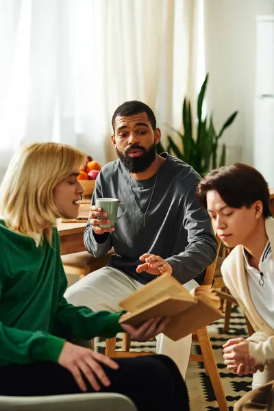 Group of handsome young men share insights and ideas during a casual reading club meeting at home. — Stock Photo