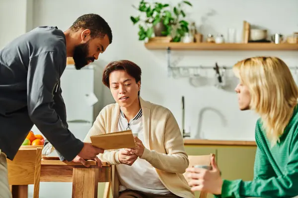 Young men gather in a modern home, sharing ideas and bonding over books casually. — Stock Photo