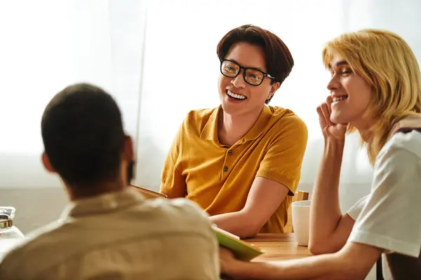Young men bond over literature in a warm, lively atmosphere filled with conversation. — Stock Photo
