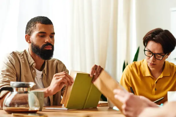 Handsome young men share their thoughts on books during a vibrant gathering at home. — Stock Photo