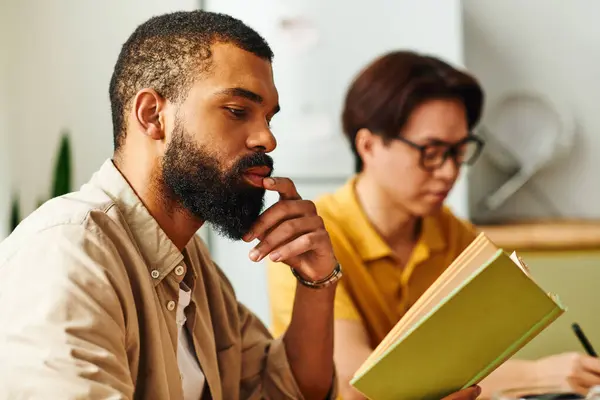 Young men gather in a stylish home setting for meaningful conversations and reading activities. — Stock Photo