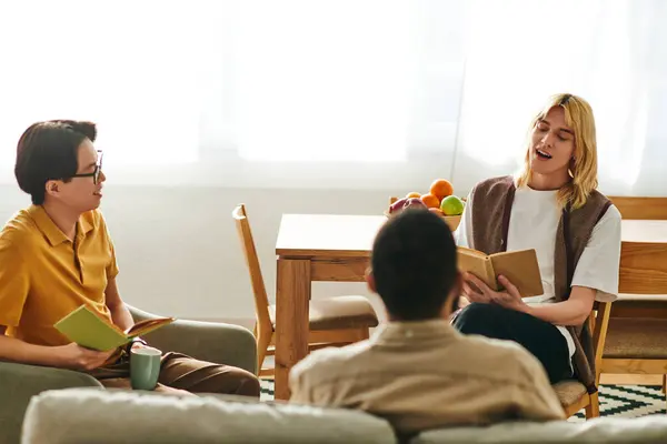 A group of young, stylish men share ideas and insights while enjoying a book club meeting at home. — Stock Photo