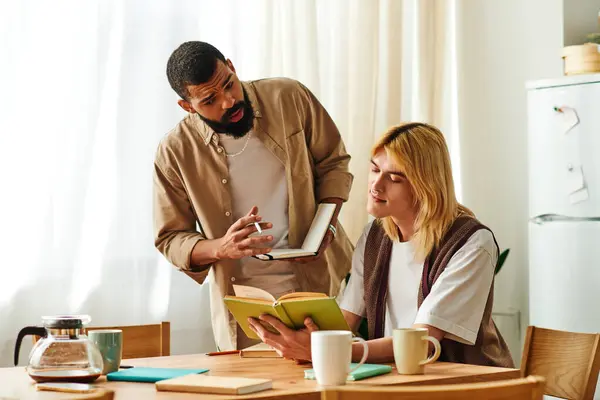 Two handsome young men share insights and ideas during a relaxed book club meeting at home. — Stock Photo