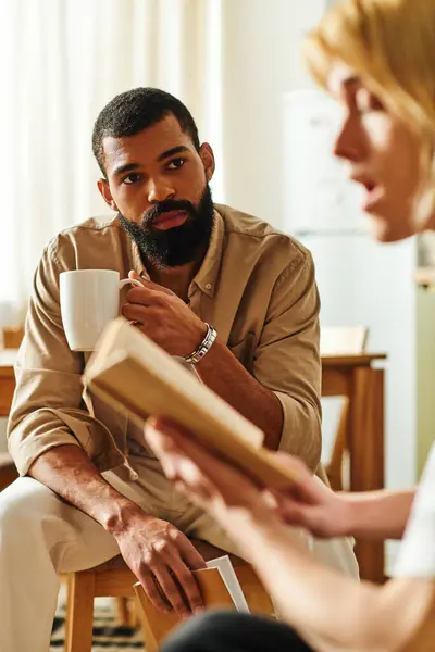 Group of diverse young men bond over ideas and stories at a casual reading club gathering. — Stock Photo
