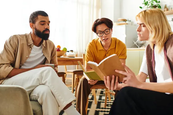 Three handsome young men share insights in a modern reading club, enjoying each others company. — Stock Photo