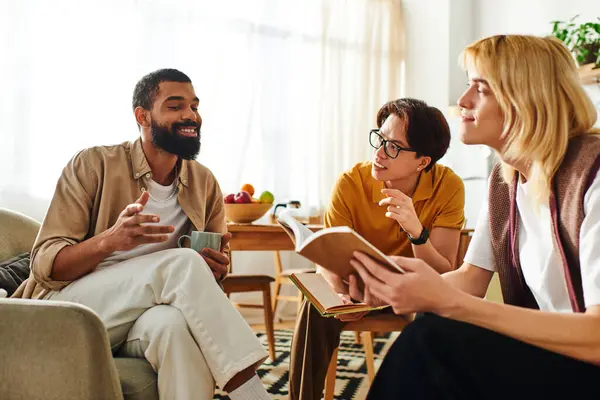 Three young, diverse men bond over literature and discussions in a stylish home setting. — Stock Photo