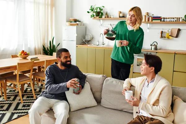 Three young, handsome men enjoy lively conversations while sharing drinks in a warm home setting. — Stock Photo