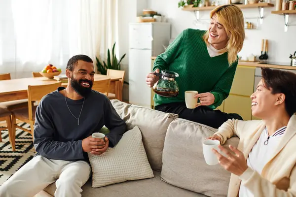 Three handsome young men have lively talks over drinks in a cozy home setting. — Stock Photo