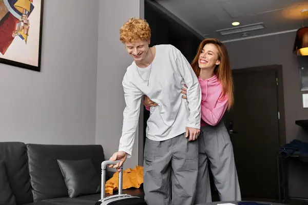 A happy young couple shares a loving moment while planning their trip at the hotel. — Stock Photo