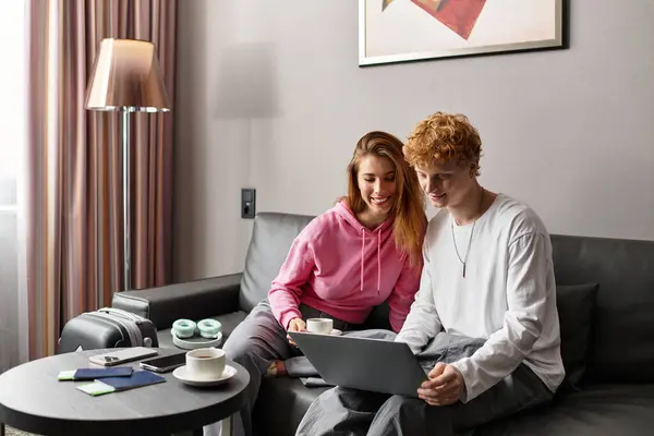 Couple enjoys a joyful hotel stay, planning their next adventure with warmth and connection. — Stock Photo