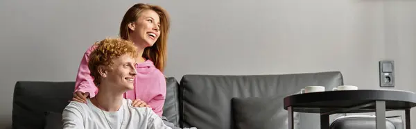 A young couple enjoys a joyful moment in a chic hotel room, embracing their bond. — Stock Photo