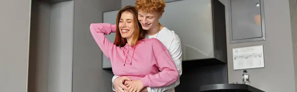 A young couple enjoys a special moment in a hotel room, radiating joy and affection for each other. — Stock Photo